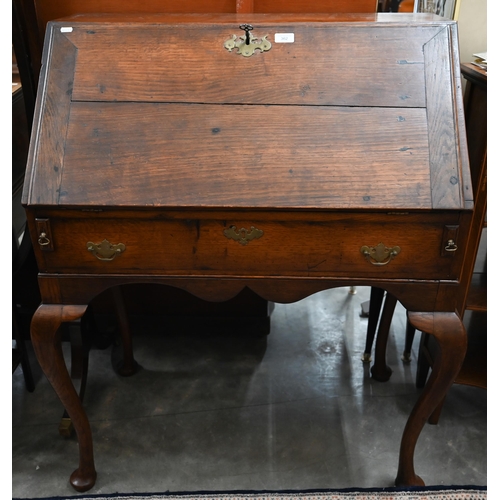 362 - A Georgian oak fall front bureau on stand with fitted interior and dummy drawer raised on pad footed... 