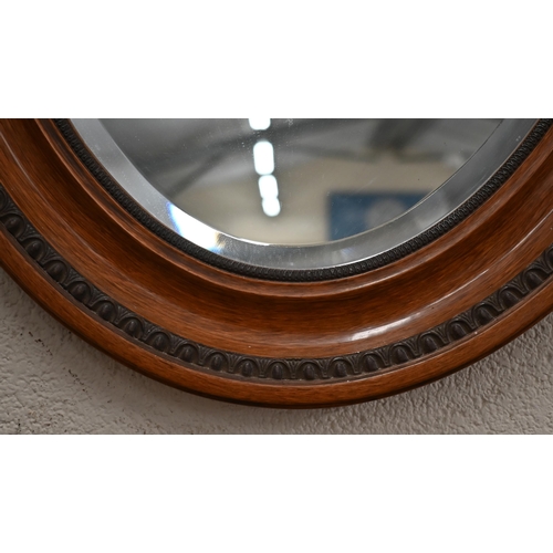 373 - A bevelled oval wall mirror with egg and dart carved mahogany frame 78 cm x 50 cm to/w another bevel... 