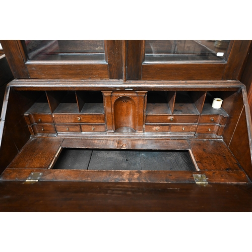 376 - #A German oak bureau bookcase with glazed doors over a fall-front panel enclosing fitted interior an... 