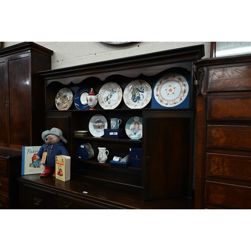 383 - A Georgian style oak dresser, the raised back with open shelves and cupboards on the base with four ... 