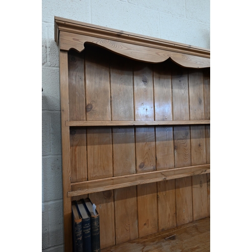 387 - A stripped pine kitchen dresser with two-shelf plate rack on a base with three drawers and panelled ... 