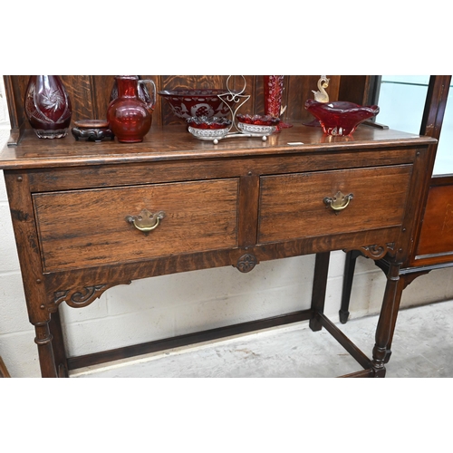 389 - An early 20th century small oak dresser, the plate rack with two shelves on two drawer base with tur... 