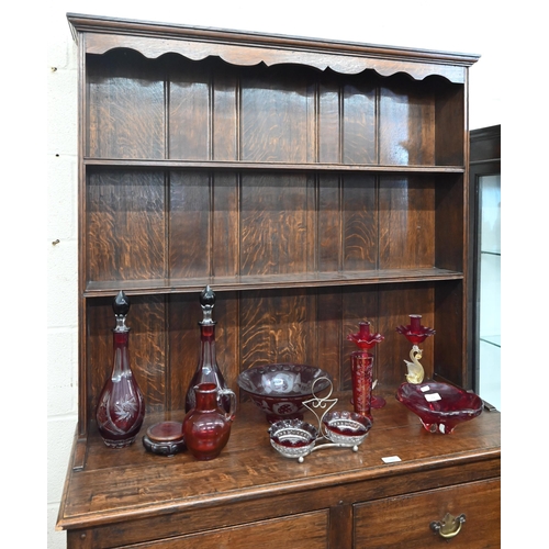 389 - An early 20th century small oak dresser, the plate rack with two shelves on two drawer base with tur... 