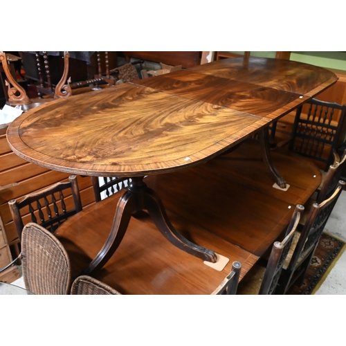 39 - #A Victorian style D-end mahogany twin pedestal dining table with extension leaf, on carved paw feet... 