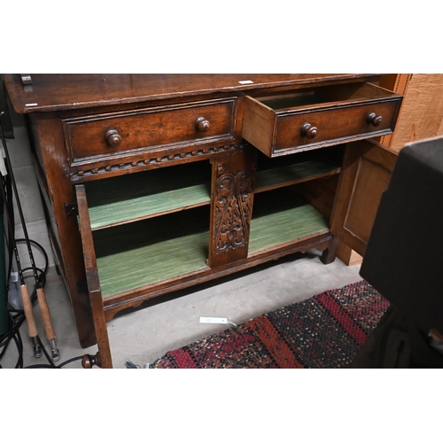 391 - A small early 20th century carved oak dresser, the shallow plate rack with three shelves on a base w... 