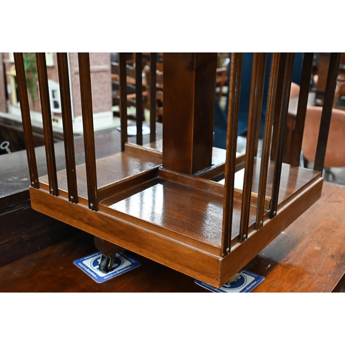 403 - A small inlaid walnut revolving bookcase on cruciform base with casters 46 cm x 46 cm x 78 cm h