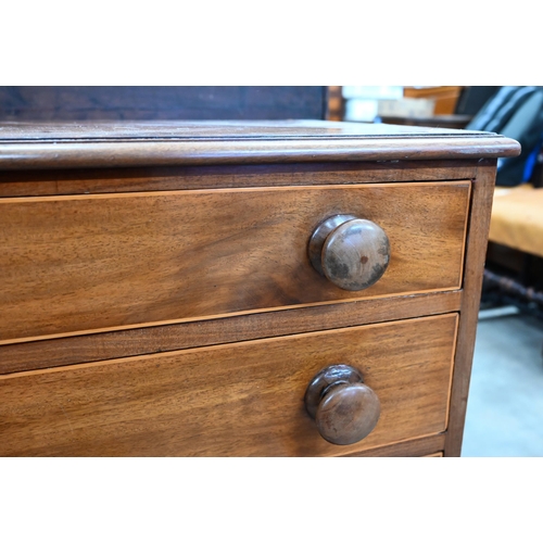 408 - A small Victorian mahogany chest of four long graduating drawers with turned handles, raised on spla... 