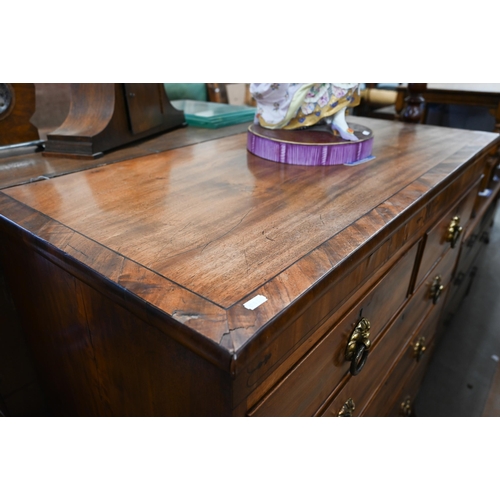 414 - A 19th century mahogany chest of two short over three long drawers with brass handles raised on spla... 