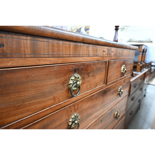 414 - A 19th century mahogany chest of two short over three long drawers with brass handles raised on spla... 