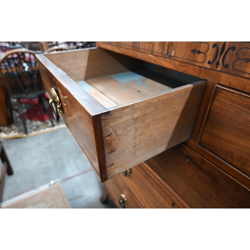 414 - A 19th century mahogany chest of two short over three long drawers with brass handles raised on spla... 