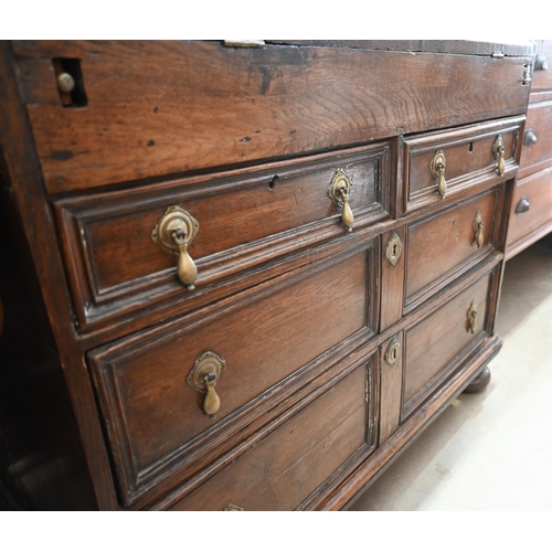 421 - An antique oak fall front bureau with fitted interior and six drawers standing on bun feet 94 cm w x... 