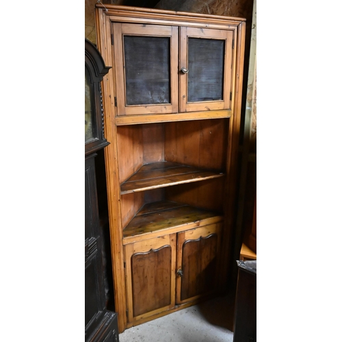 43 - An antique full height pine kitchen larder corner cabinet, with a pair of perforated panelled doors ... 