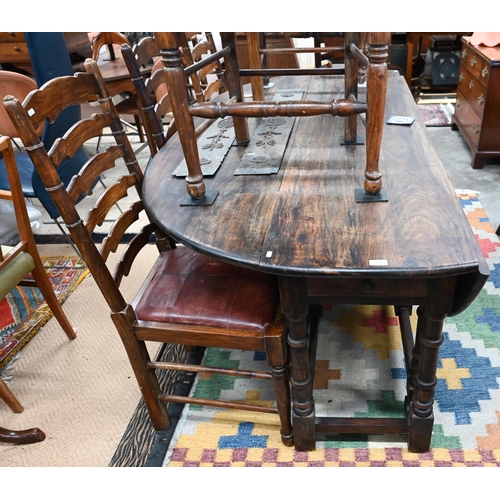 433 - A substantial reproduction hardwood wake/dining table with two drawers raised on turned gate-leg act... 