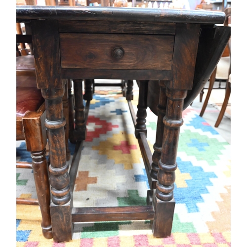 433 - A substantial reproduction hardwood wake/dining table with two drawers raised on turned gate-leg act... 