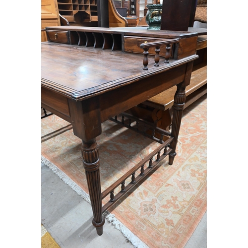 434 - A reproduction stained hardwood writing table with galleried top, turned and reeded supports united ... 