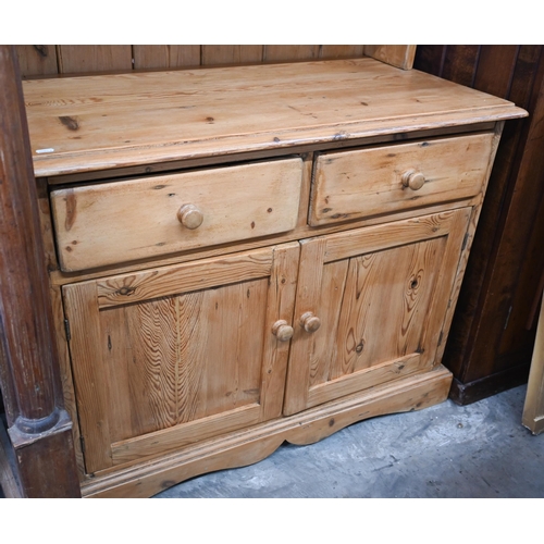 442 - A small waxed pine kitchen dresser with three shelves over drawers and panelled cupboards, 96 cm wid... 