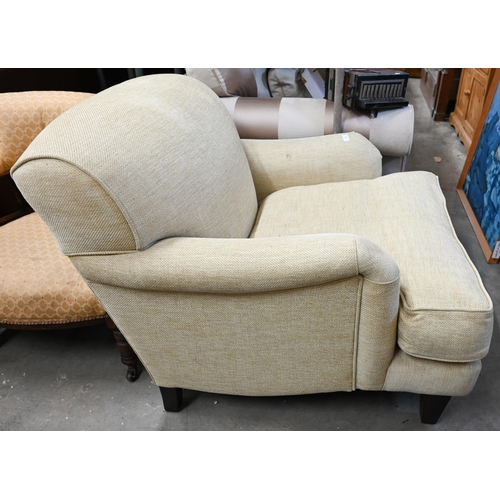 446 - A Highly Sprung Howard-style armchair in buttermilk chenille upholstery on tapering hardwood support... 