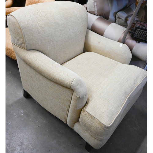 446 - A Highly Sprung Howard-style armchair in buttermilk chenille upholstery on tapering hardwood support... 