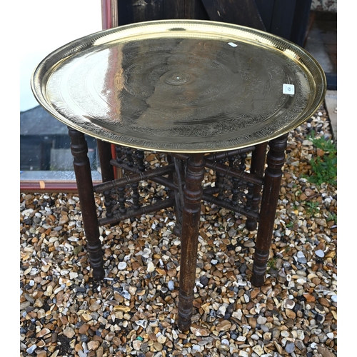 454 - A Middle Eastern brass tray top table on folding bobbin-turned base 57 diam x 54 cm high to/w mahoga... 