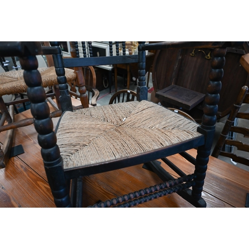 456 - Antique ebonised bobbin framed rocking chair with woven rush seat 