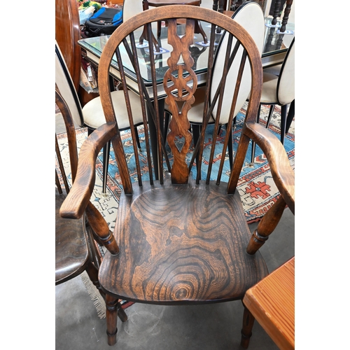 459 - A set of six provincial elm and ash wheelback dining chairs on turned supports comprising two carver... 