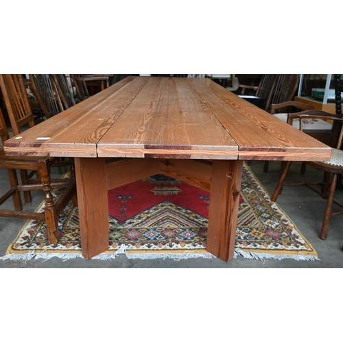 462 - A substantial rustic pitch pine rectangular dining table with multi-planked top on angled rectangula... 