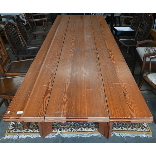 462 - A substantial rustic pitch pine rectangular dining table with multi-planked top on angled rectangula... 