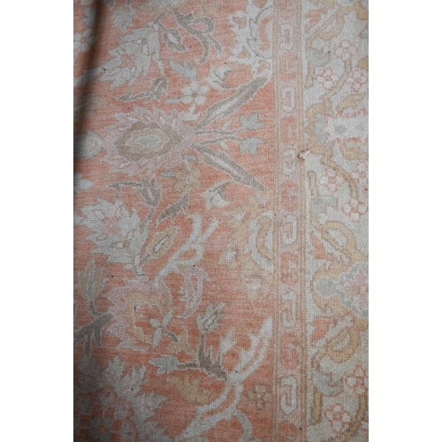 463 - An Indo-Persian Agra carpet, the traditional floral design on peach ground guarded camel border with... 