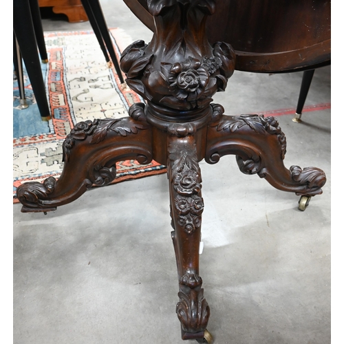 464 - A Victorian mahogany circular tilt-top table with floral and foliate carved base with baluster colum... 