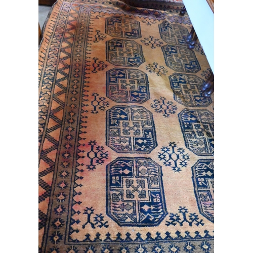 465 - A Golden Afghan rug, repeating gul design within dark repeating borders and kelim ends, 216 x 157 cm