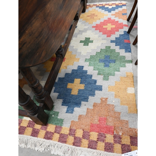 467 - A multi-coloured geometric design kelim rug, 200 x 140 cm