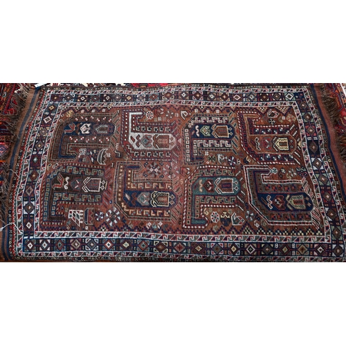 47 - An old Persian design Shiraz rug, the design of eight large boteh on brown ground within repeating d... 