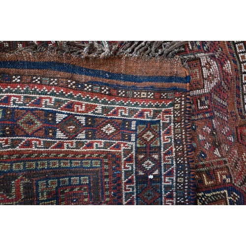 47 - An old Persian design Shiraz rug, the design of eight large boteh on brown ground within repeating d... 