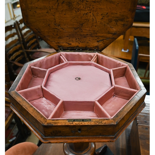 475 - A Victorian walnut octagonal sewing table with fitted silk lined interior tapering column and trifor... 