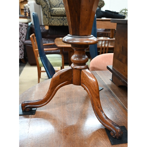 475 - A Victorian walnut octagonal sewing table with fitted silk lined interior tapering column and trifor... 