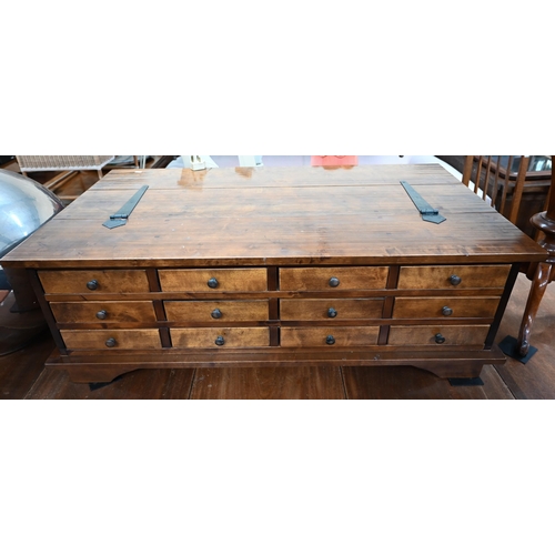 479 - A Laura Ashley hardwood coffee table with hinged top and 12 drawers to one side, standing on bracket... 