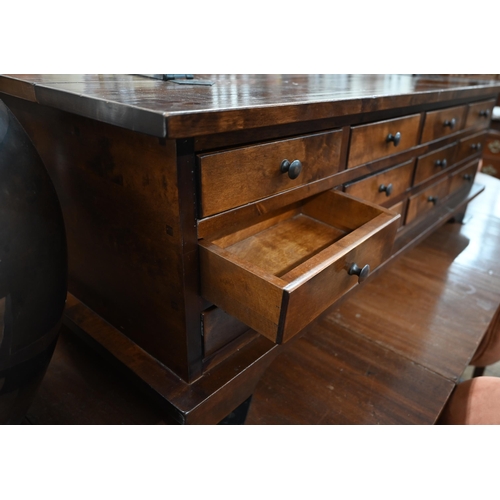 479 - A Laura Ashley hardwood coffee table with hinged top and 12 drawers to one side, standing on bracket... 