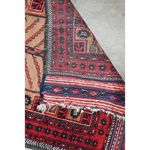 488 - A Persian Baluch tan ground rug, flora and fauna designs and red border with kelim ends, 190 x 94 cm