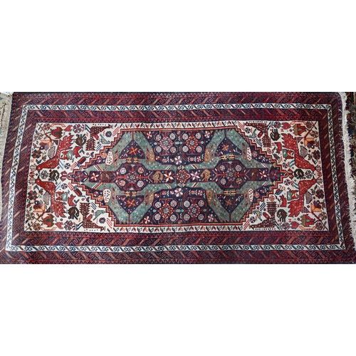 49 - A vintage Persian Hamadan rug, the geometric medallion designs on dark blue ground within repeating ... 