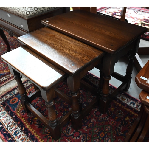 493 - A nest of three 1970s teak tables, the largest with inset tile-top to/w Old Charm style nest of oak ... 