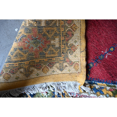 499 - Turkish carpet geometric design with blue diamond medallion on red ground, cream and mustard repeati... 