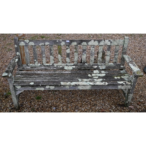 5 - A heavily weathered teak garden bench to/with a pair of equally weathered teak chairs (3)