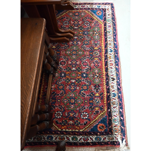 548 - A pair of Persian Hamadan rugs, each with all-over rosettes/floral designs on red ground, blue and c... 