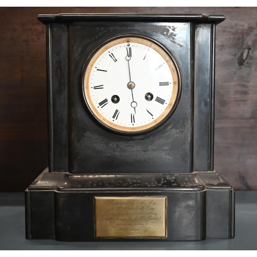 553 - A late 19th century architectural slate mantel clock with twin-train drum movement striking on a bel... 