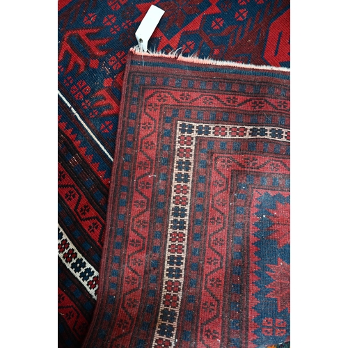 565 - A Persian Baluch rug, scattered rosettes on blue ground and guarded rosette border in cream, 200 x 1... 