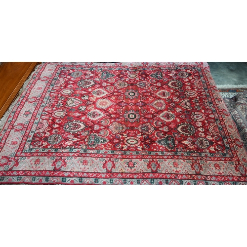 568 - A small Persian carpet, arrangemtn of rosettes and palmettes on ruby red ground, floral cream border... 