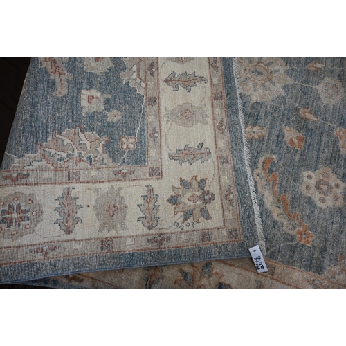 571 - An Indo-Persian Ziegler design carpet, duck-egg blue ground with typical floral design, beige rosett... 