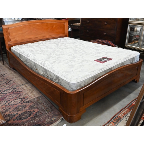 572 - A cherrywood queen size double bed with panelled headboard and reeded detailing c/w hinged storage-b... 