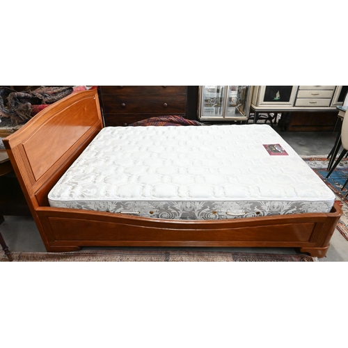 572 - A cherrywood queen size double bed with panelled headboard and reeded detailing c/w hinged storage-b... 