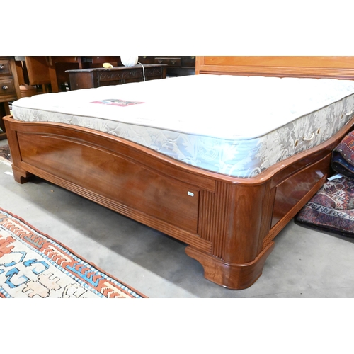 572 - A cherrywood queen size double bed with panelled headboard and reeded detailing c/w hinged storage-b... 